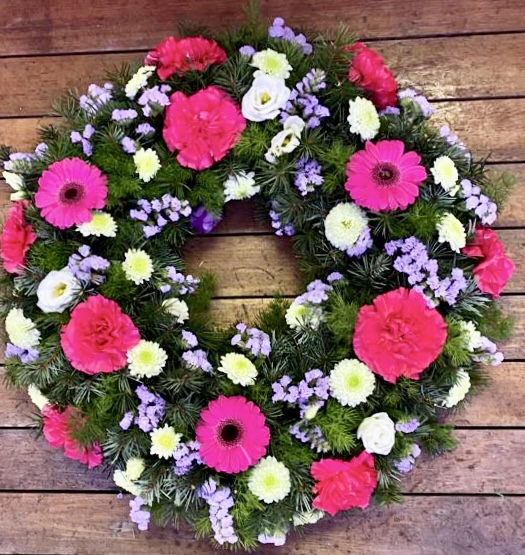 This beautiful lilac and white wreath, symbolising peace and serenity. This elegant arrangement combines lush blue blooms with pure white flowers, offering a heartfelt tribute of respect and remembrance. Perfect for expressing condolences and bringing comfort during a time of loss. Each wreath is carefully crafted to ensure it reflects both beauty and grace during this difficult time.