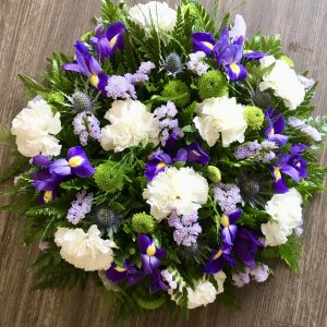 A charming posy pad in delicate shades of lilac blue and white. Available in any colours. Same day delivery. Due to seasonal variations some items may be substituted to produce a display of equal quality and value. Professionally arranged by our expert florists with care. Delivered by hand by our own driver. Click & collect is also available