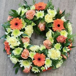A beautiful traditional wreath in a striking orange and lemon tones Colours of your choice. same day delivery available Due to seasonal variations some items may be substituted to produce a display of equal quality and value. Professionally arranged by our expert florists with care. Delivered by hand by our own driver. Click & collect is also available.