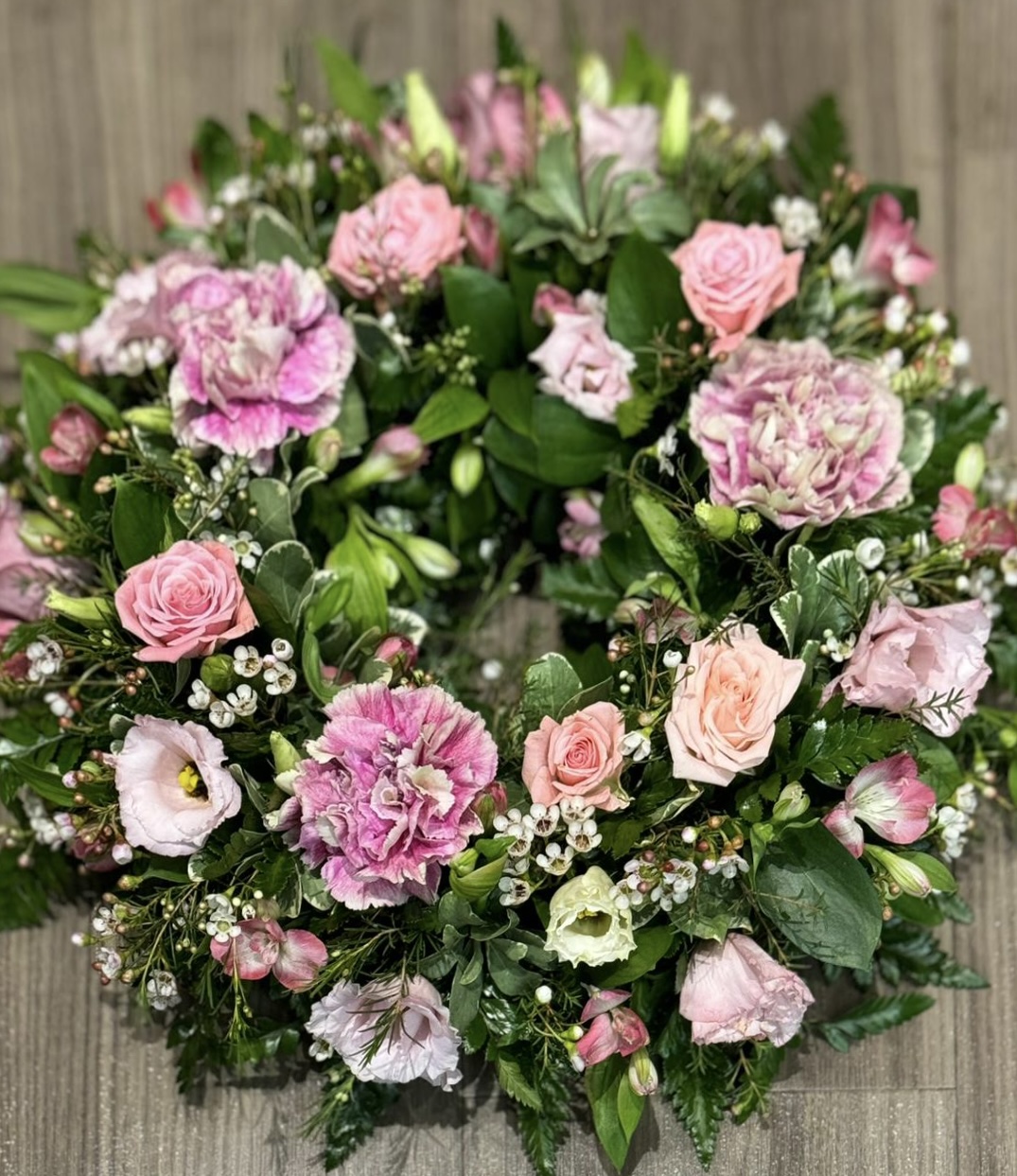 This beautiful lime and white wreath, symbolising peace and serenity. This elegant arrangement combines lush blue blooms with pure white flowers, offering a heartfelt tribute of respect and remembrance. Perfect for expressing condolences and bringing comfort during a time of loss. Each wreath is carefully crafted to ensure it reflects both beauty and grace during this difficult time.